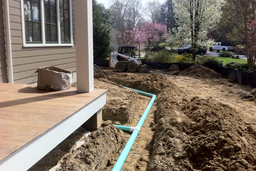 Yard drainage installation moving water away from a home